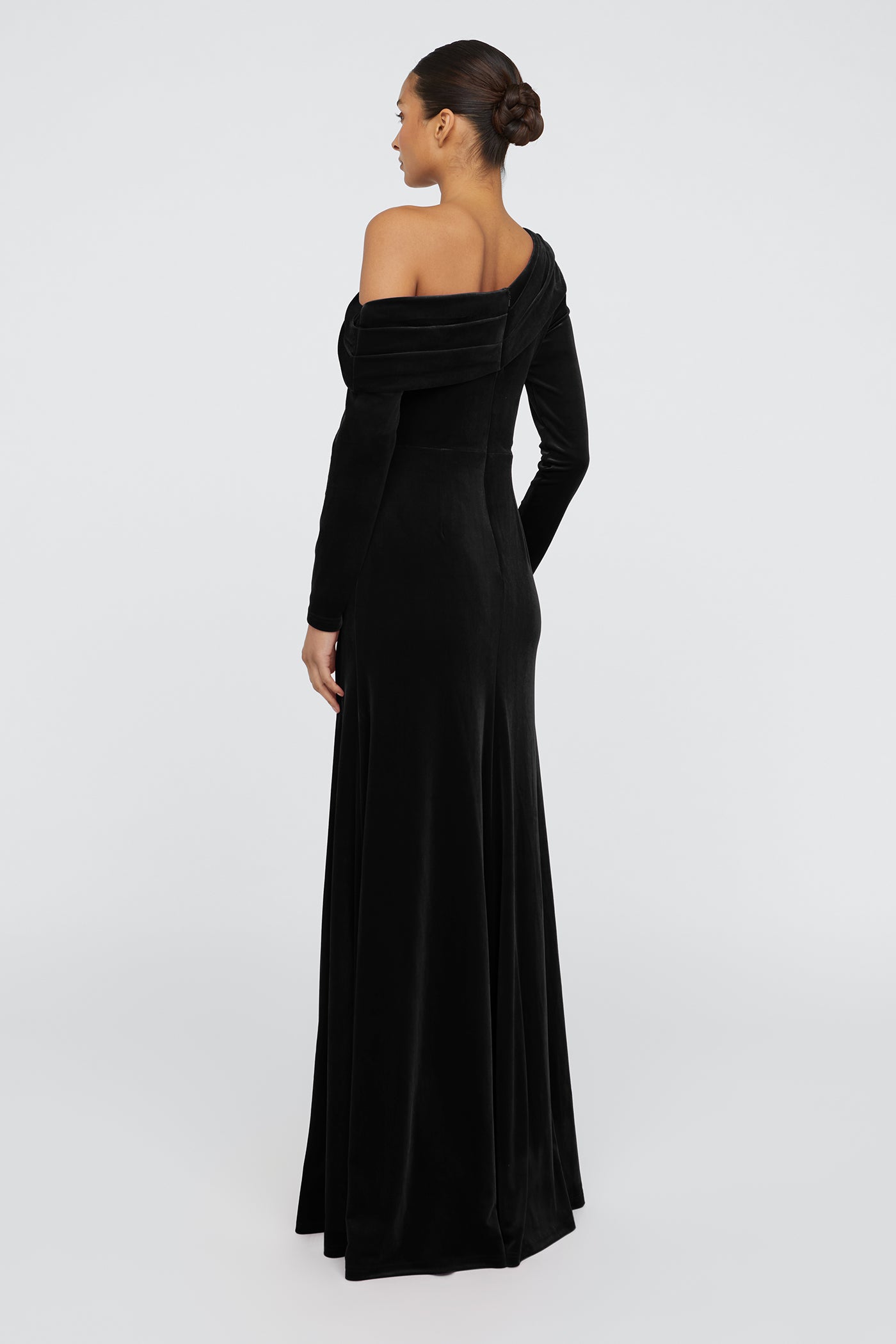 Woman wearing a black off-shoulder gown on a white background
