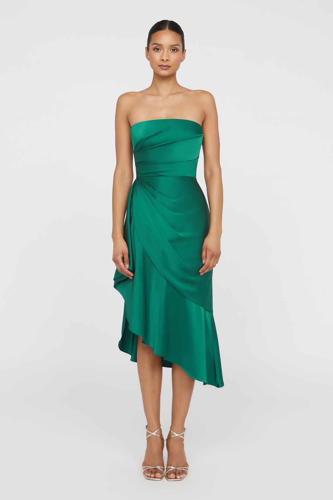 Woman wearing a green strapless dress on a white background
