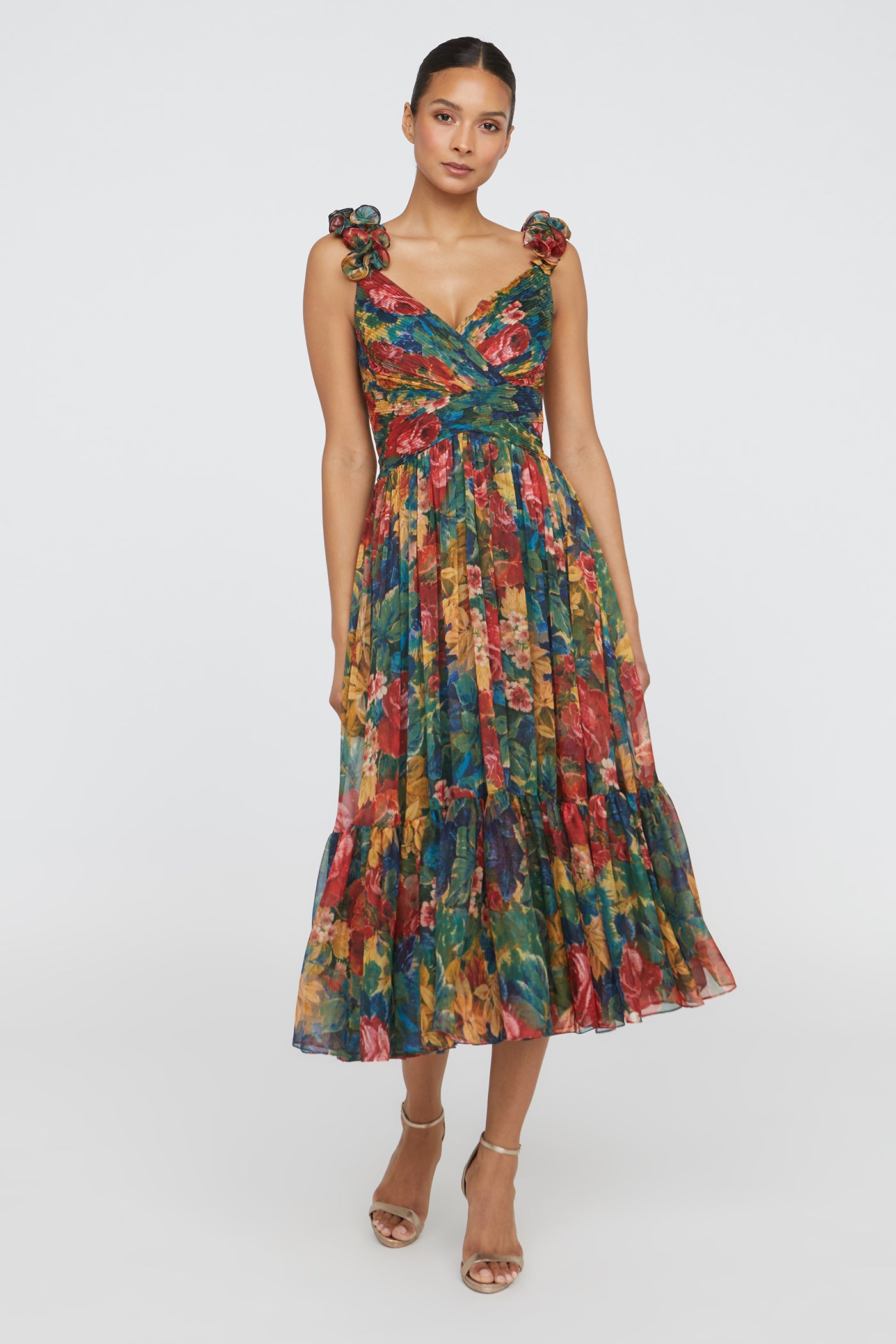 Woman wearing a colorful floral dress on a white background