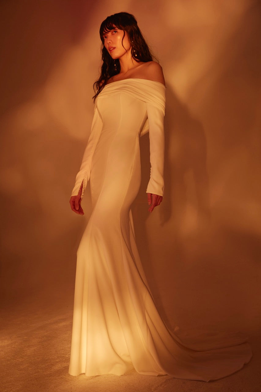 Off the shoulder draped long sleeve stretch crepe siren gown with asymmetric twist train