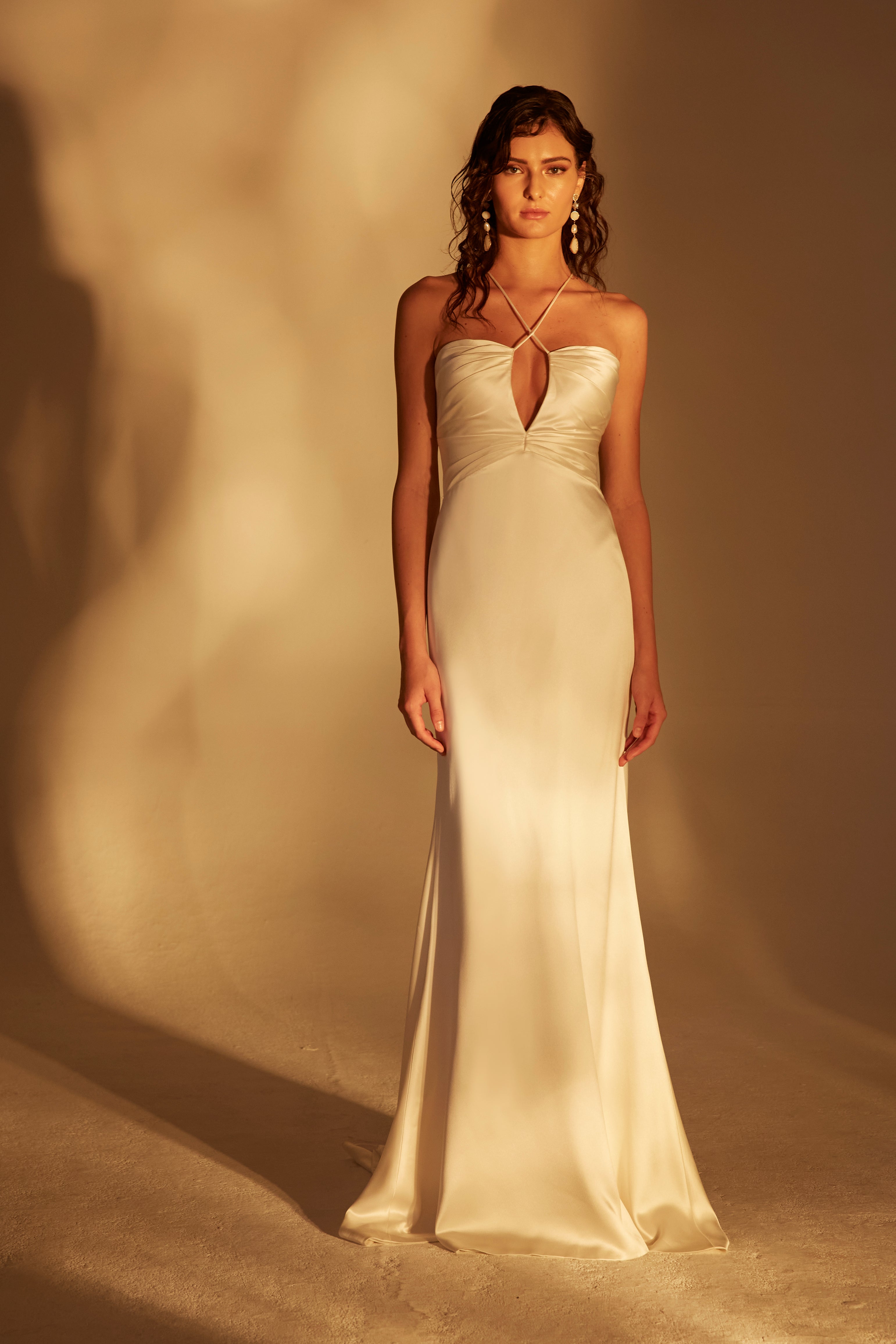 High sheen satin gown with ruched peekaboo bodice and criss cross spaghetti straps