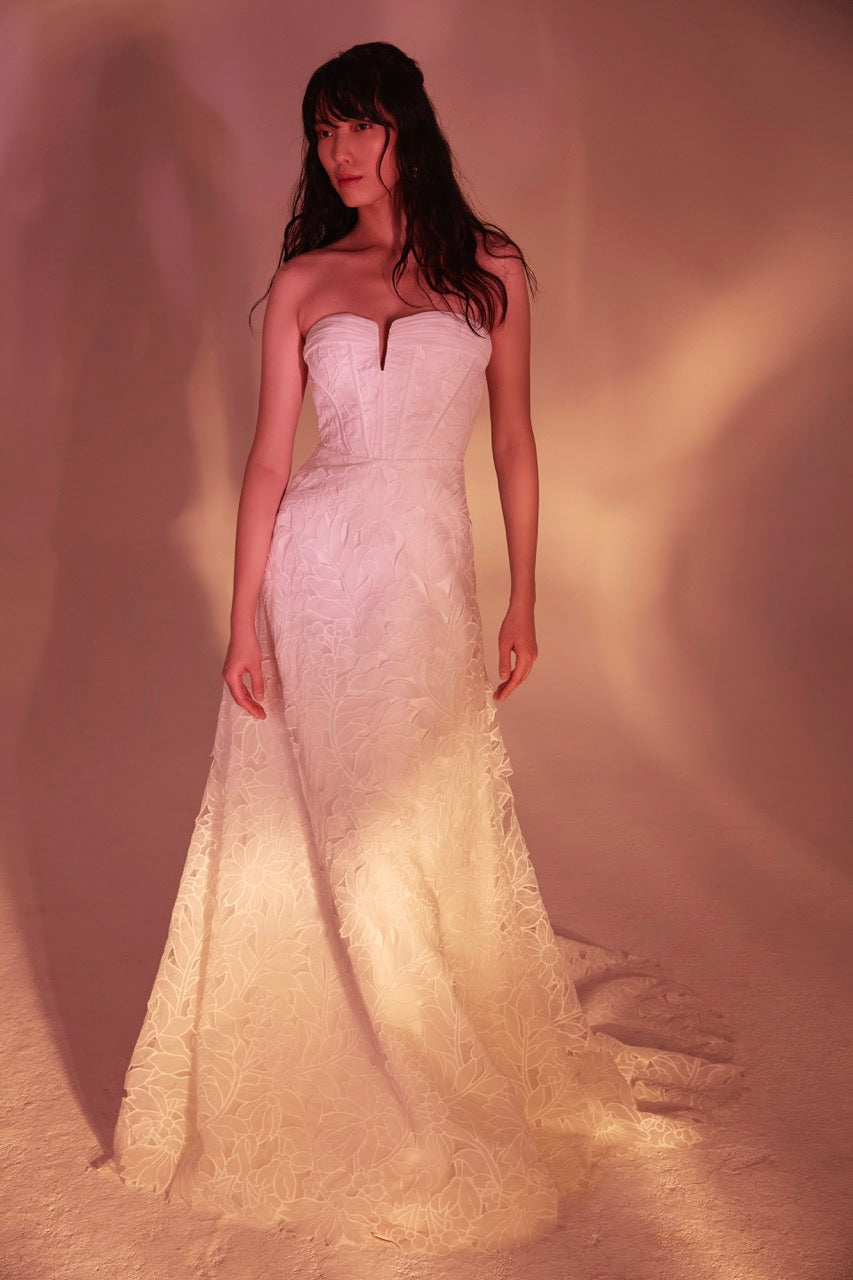 Floral cutwork strapless modified a-line gown with exposed boning.
