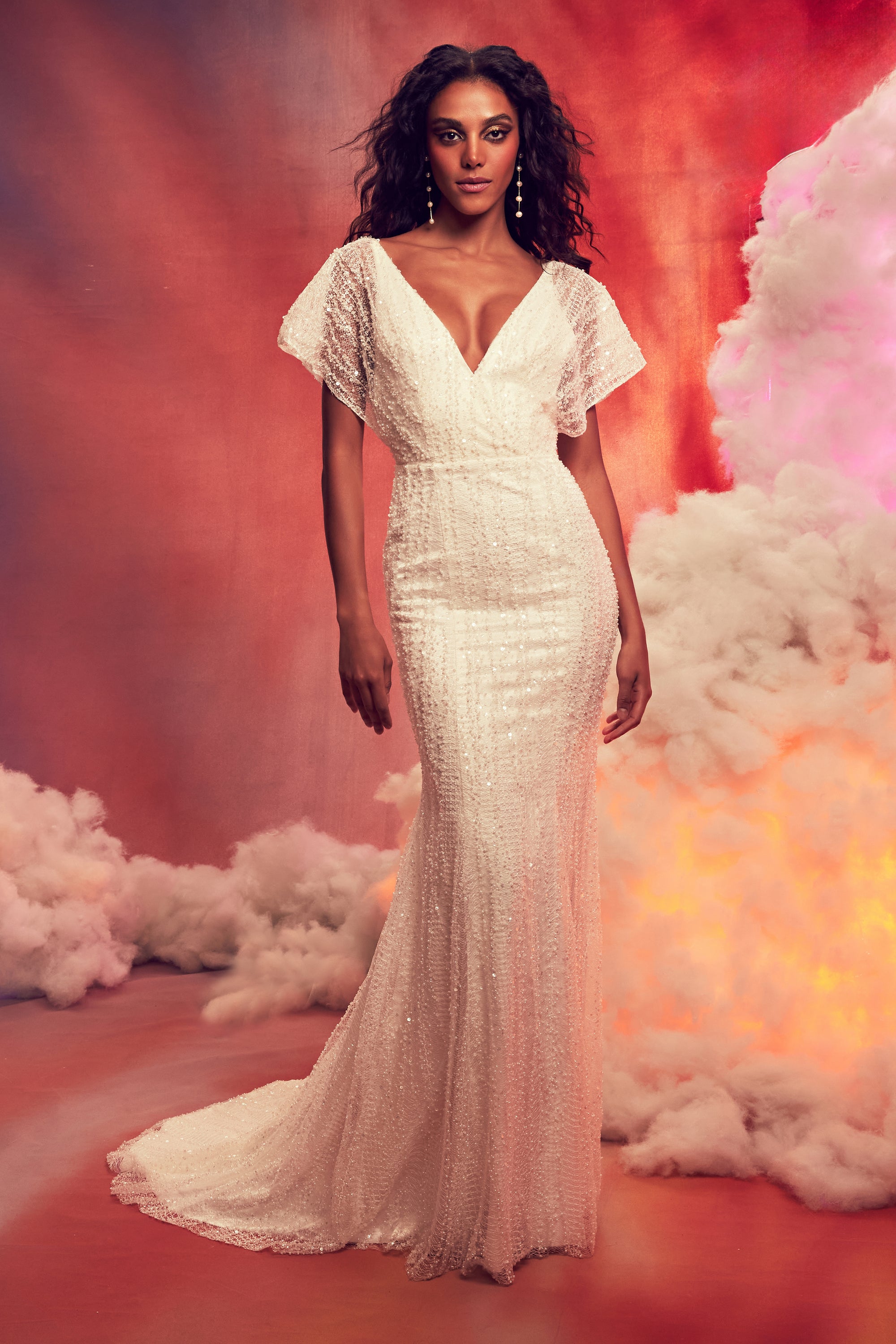 Crystalline beaded shealth gown with dolman sleeve and open tie back.